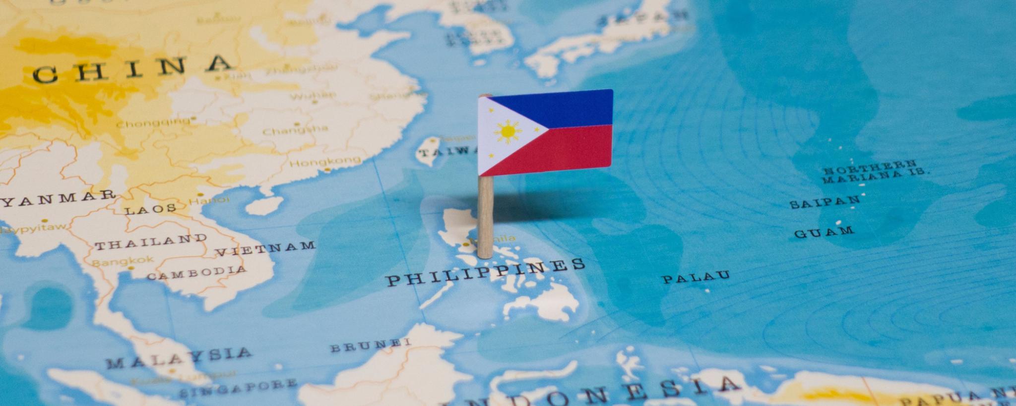 Philippines flag pinned on a map of the Philippines and Pacific 