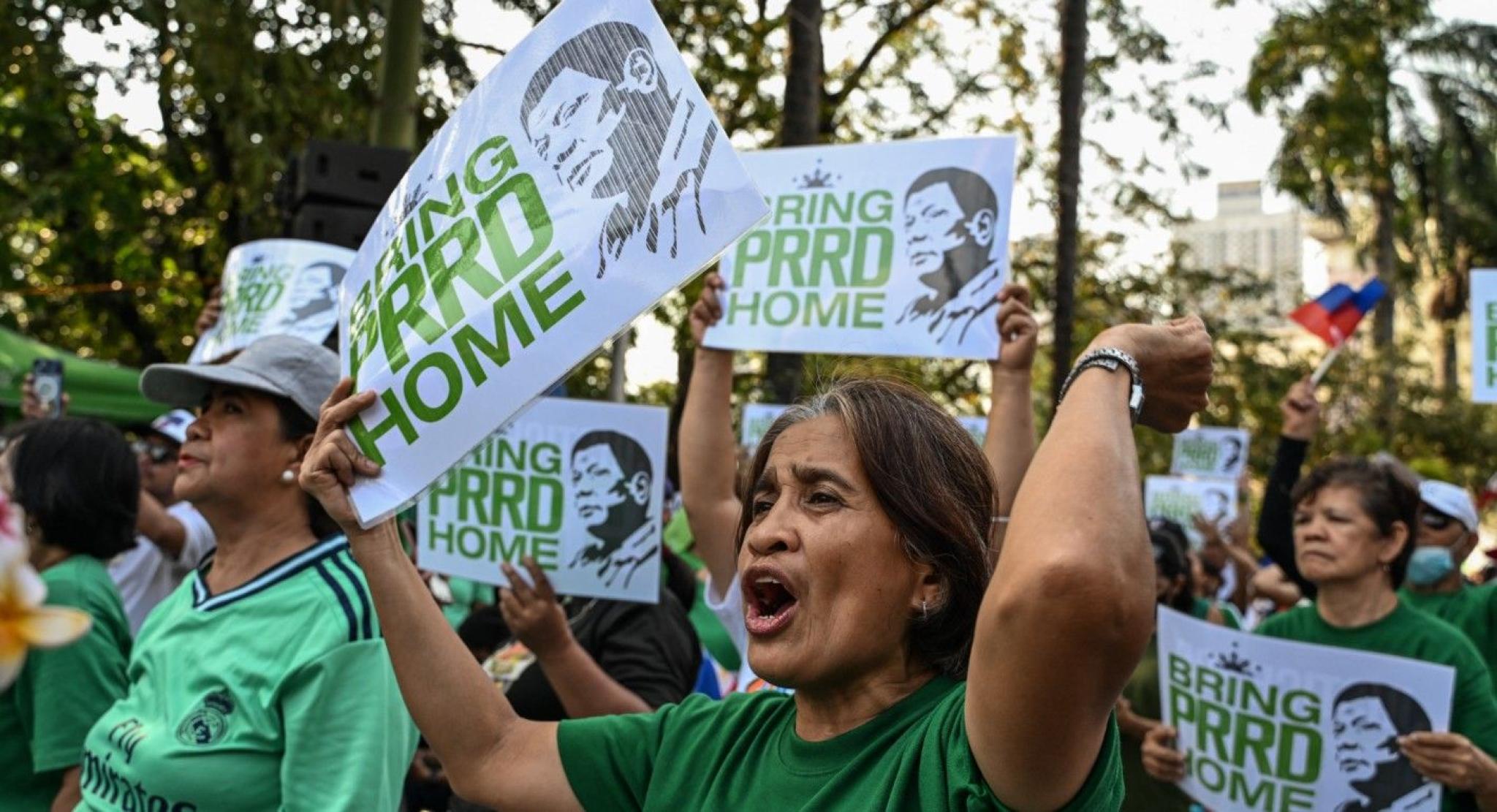 Protests in the Philippines. People holding posters saying 'Bring PRRD Home'
