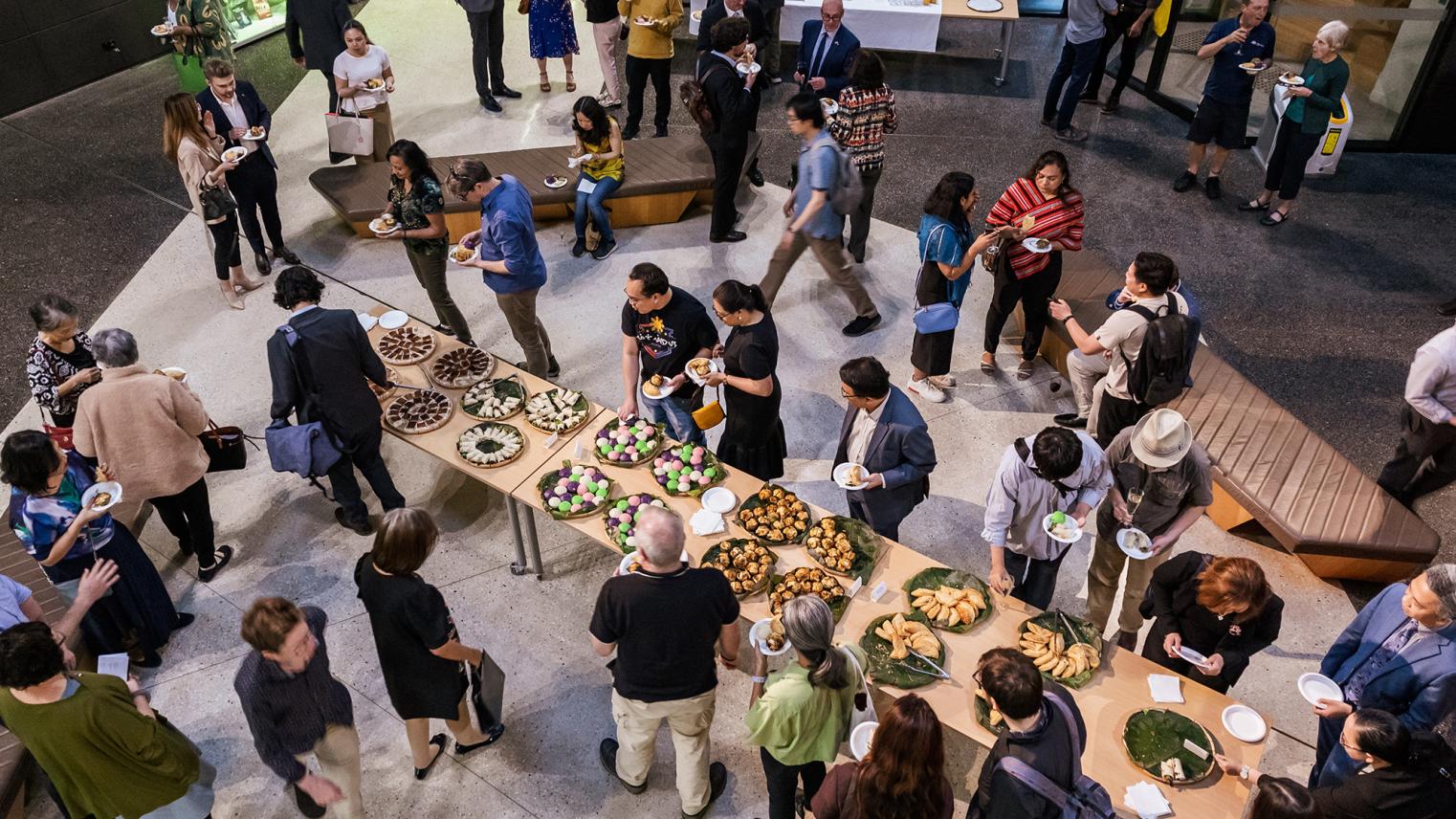 Pacific Institute Launch. top-down view of food table with guests